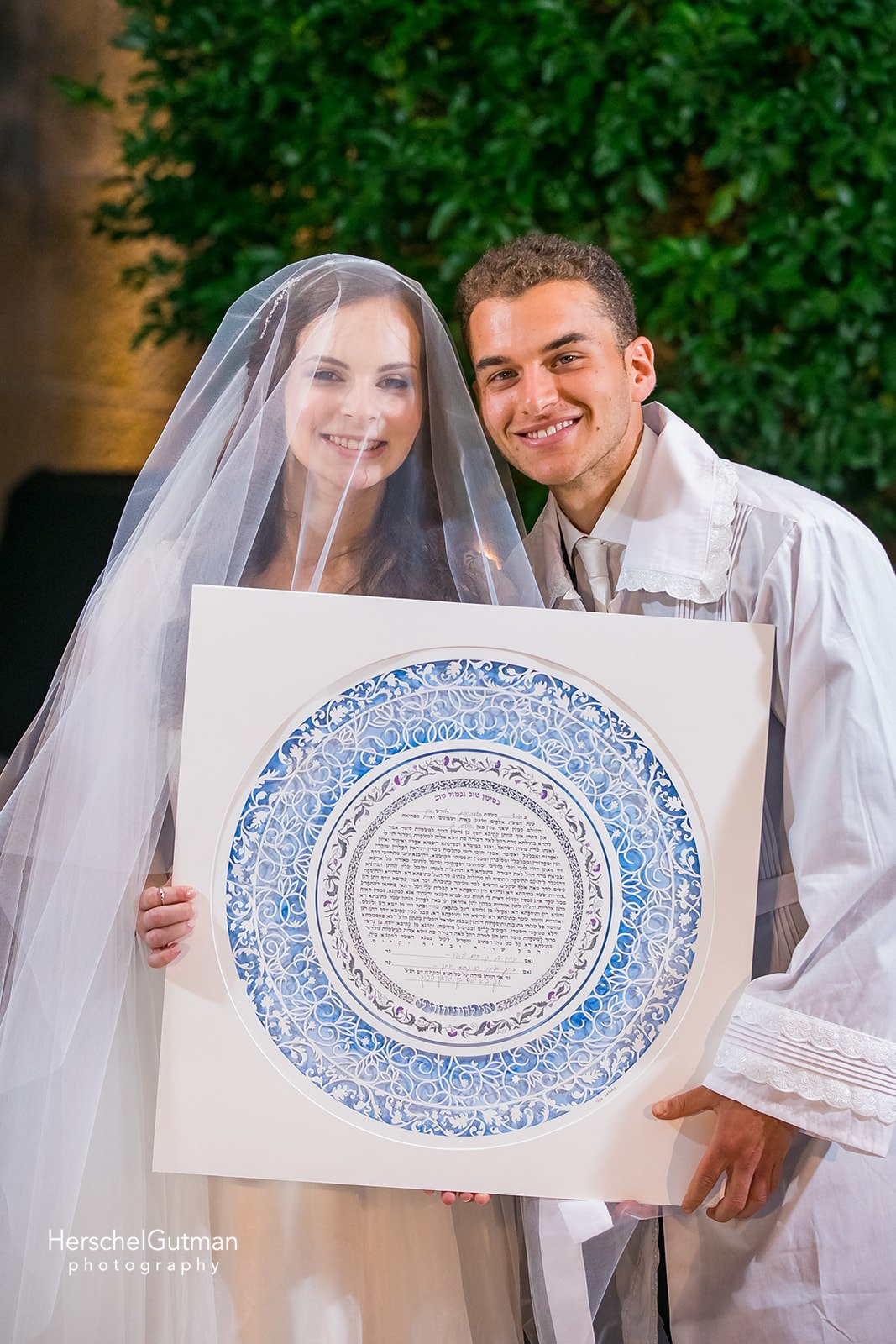 A non-Jewish couple proudly holding their customized Ketubah